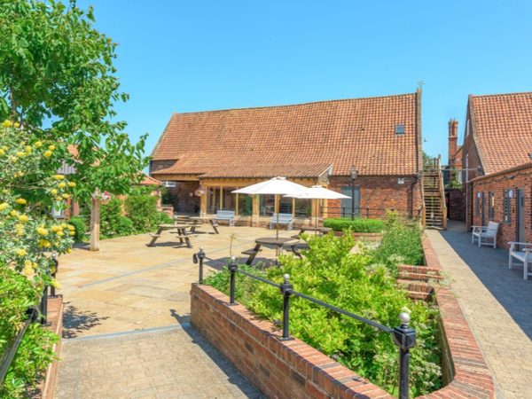 cottage courtyard with seating and trees