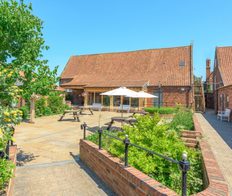 cottage courtyard with seating and trees