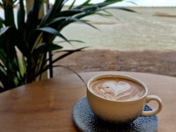 coffee with love heart latte art with frampton marsh nature reserve outside window of cafe