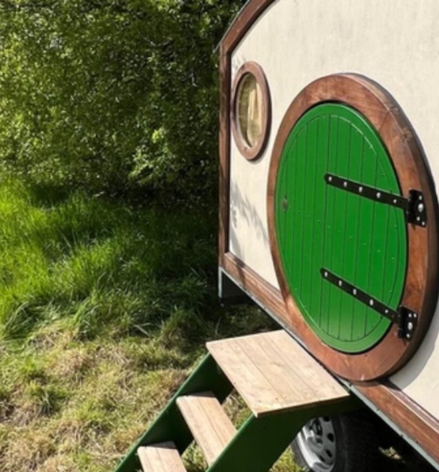 small wooden hobbit themed accommodation lodge in the trees